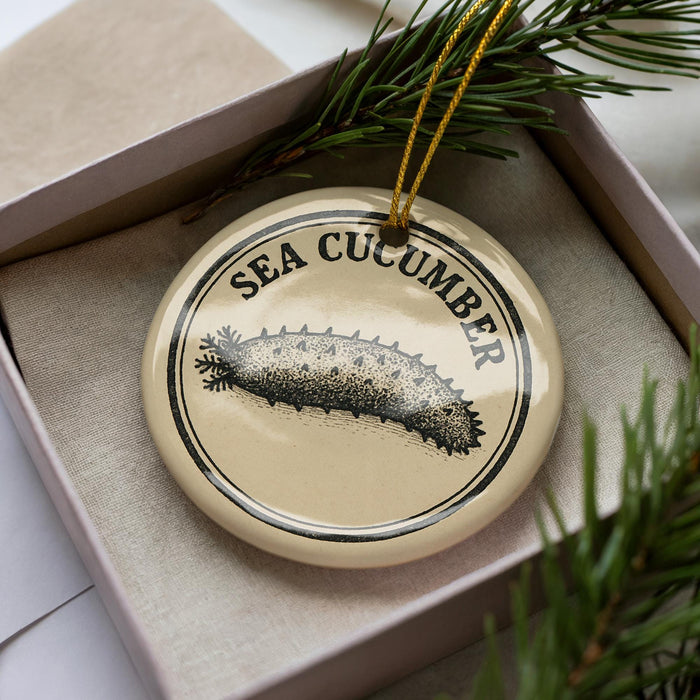 A decorative ornament in a box, featuring a sea cucumber illustration.