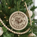A Christmas tree decorated with ornaments, including a circular ornament with a dog's head and the text "SEALYHAM TERRIER" printed on it.