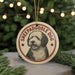 A circular ornament featuring a dog's face, with the text "SHEPADOOLE DOG" printed on it, hanging from a string.