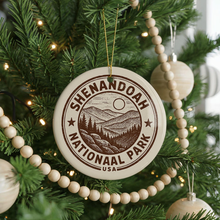 A circular ornament on a Christmas tree, featuring the text "Shenandoah National Park" and a mountain landscape.