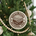 A circular ornament on a Christmas tree, featuring the text "Shenandoah National Park" and a mountain landscape.