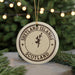 A circular ornament with the text "SHETLAND ISLANDS SCOTLAND" printed on it, surrounded by a Christmas tree and twinkling lights.
