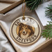 A circular ornament with a dog's face and the text "SHETLAND SHEEPDOG" printed on it, hanging from a string.