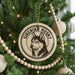 A round ornament on a Christmas tree featuring a picture of a Siberian husky.