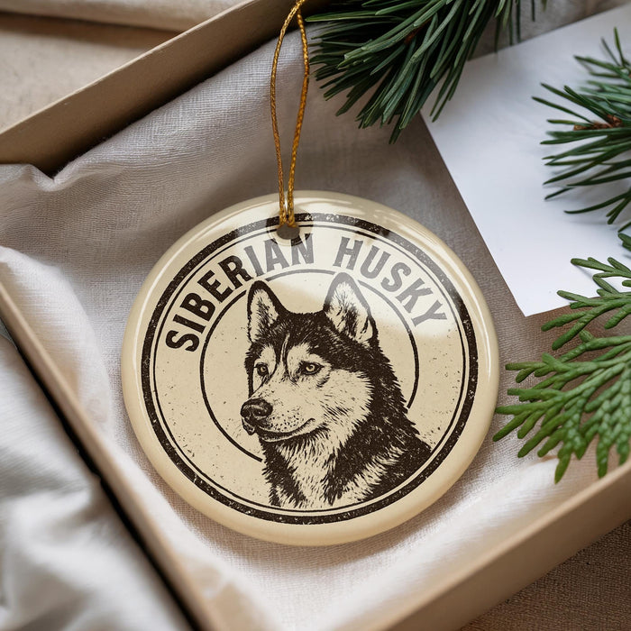 A round ornament featuring a black and white illustration of a Siberian husky dog.