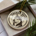 A ceramic ornament in a box, featuring a close-up image of a Siberian husky dog.