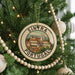 A circular ornament on a Christmas tree, featuring a picture of a cityscape with the text "SINTRA PORTUGAL" around the edge.