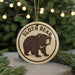 A round ornament featuring a sloth bear image, with the text "SLOTH BEAR" printed on it.