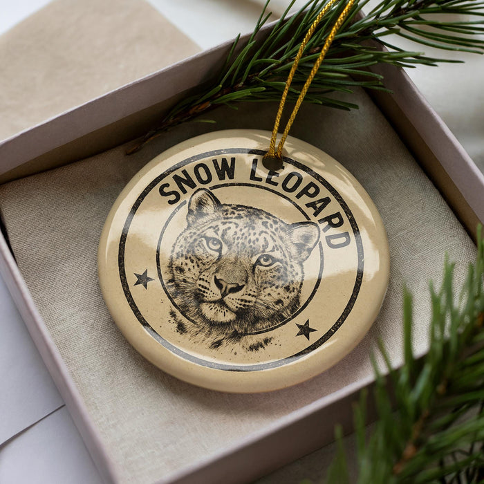 A decorative ornament featuring a snow leopard's face, with the text "SNOW LEOPARD" prominently displayed.