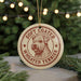 A round ornament with a dog's head and the text "Soft Coated Wheaten Terrier" printed on it, hanging from a string.