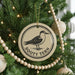 A Christmas tree decorated with ornaments, including a circular ornament with a bird image and the text "Sooty Tern" on it.