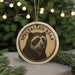 A circular ornament featuring a close-up image of a spectacled bear, with the text "SPECTACLEED BEAR" printed on it.