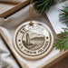 A circular ornament with the text "ST. CROIX US VIRGIN ISLANDS" printed on it, hanging from a string.