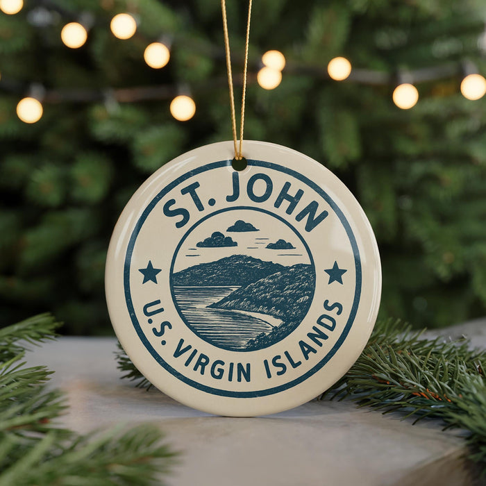 A circular ornament with the text "ST. JOHN U.S. VIRGIN ISLANDS" and a graphic of a mountain and ocean, hanging from a string.
