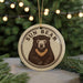 A circular ornament featuring a bear image with the text "SUN BEAR" around it, hanging from a string.