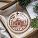 A decorative ornament featuring the Taj Mahal, a famous mausoleum in India, is displayed in a box with pine branches.