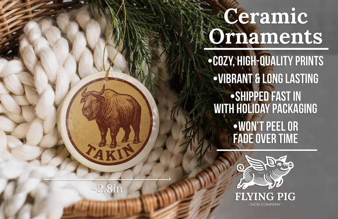 Ceramic ornaments, featuring a ceramic ornament with a brown bull image and the text "Takin" on it, hanging in a wicker basket.