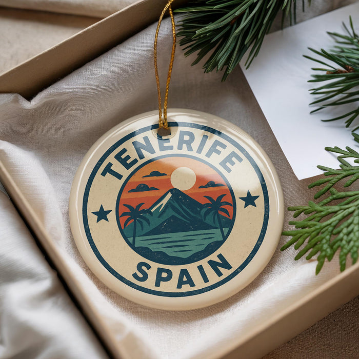 A decorative ornament with the text "Tenerife Spain" and a graphic of a mountain landscape with palm trees, hanging from a string.
