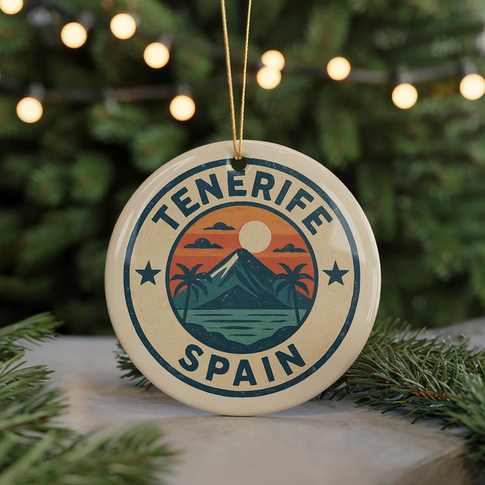 A circular ornament with the text "Tenerife Spain" and a graphic of a mountain, palm trees, and a sunset.