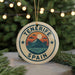 A circular ornament with the text "Tenerife Spain" and a graphic of a mountain, palm trees, and a sunset.