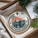 A circular ornament with the text "THE HAUGE NETHERLANDS" and an illustration of a cityscape, hanging from a string.
