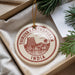 A circular ornament with the text "THRUVANANTHAPURAM" and "INDIA" printed on it, hanging from a string.