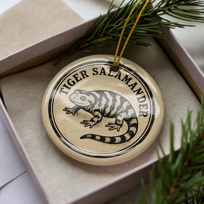 A decorative ornament in a box, featuring a black and white illustration of a salamander.