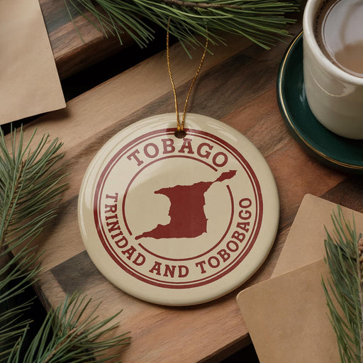 A circular ornament with the text "TOBAGO TRINIDAD AND TOBAGO" printed on it, along with a map of Trinidad and Tobago, is displayed on a wooden surface.