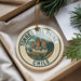 A decorative ornament with the text "TORRES DEL PAINE CHILE" on it, featuring a mountain landscape design.