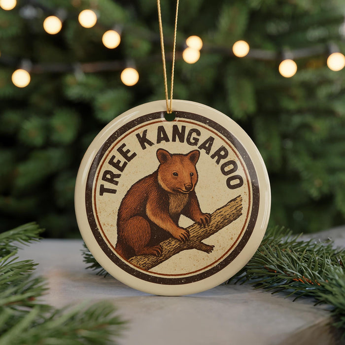 A circular ornament featuring a brown kangaroo sitting on a tree branch, with the text "TREE KANGAROO" around the image.
