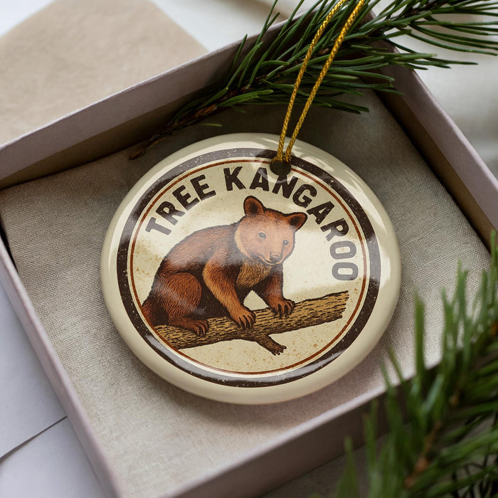A circular ornament featuring a kangaroo, a symbol of Australia, is displayed in a box with pine branches.