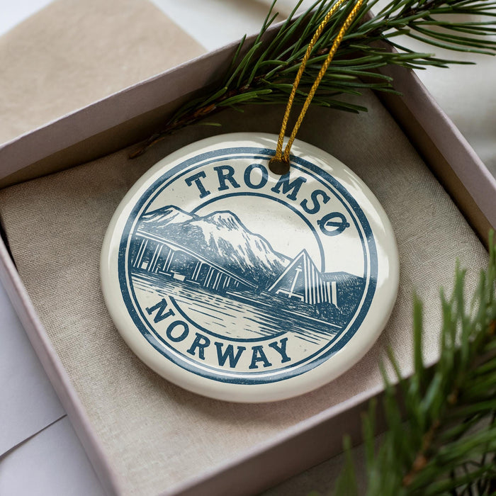 A circular ornament with the text "TROMSO NORWAY" printed on it, surrounded by pine branches.