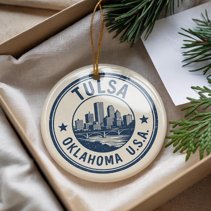 A circular ornament with the text "TULSA OKLAHOMA U.S.A." printed on it, hanging from a string.