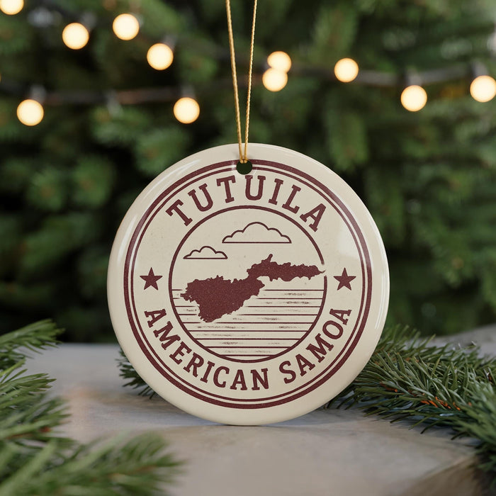 A circular ornament with the text "TUTULA AMERICAN SAMOA" and a map of the island of Tutuila, surrounded by Christmas lights and greenery.
