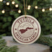 A circular ornament with the text "TUTULA AMERICAN SAMOA" and a map of the island of Tutuila, surrounded by Christmas lights and greenery.