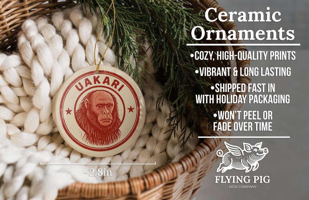 Ceramic ornaments featuring a red and white design with a gorilla face, hanging in a basket with pine branches.