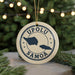 A circular ornament with the text "UPOLU SAMOA" and a map of the island of Samoa, surrounded by Christmas lights.