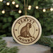 A round ornament with the text "VERVET MONKEY" and an illustration of a monkey sitting on a branch.