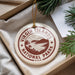 A round ornament with the text "VIRGIN ISLANDS NATIONAL PARK U.S.A." printed on it, hanging from a string.