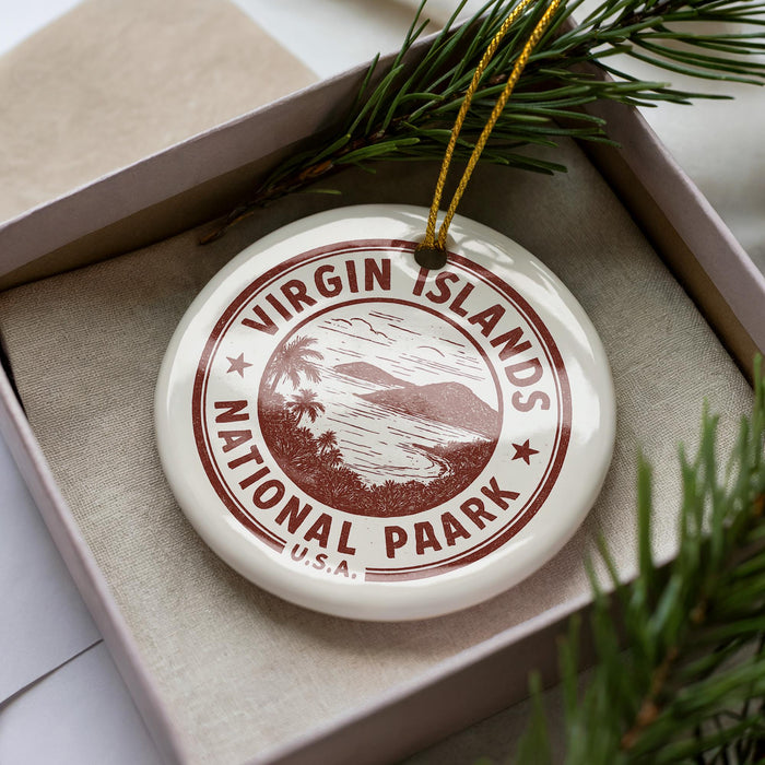 A white ornament with a red border and the text "VIRGIN ISLANDS NATIONAL PARK U.S.A." is displayed in a box, surrounded by pine branches.