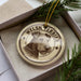 A circular ornament featuring a Welsh terrier dog's head, with the text "WELSH TERRIER" printed on it.