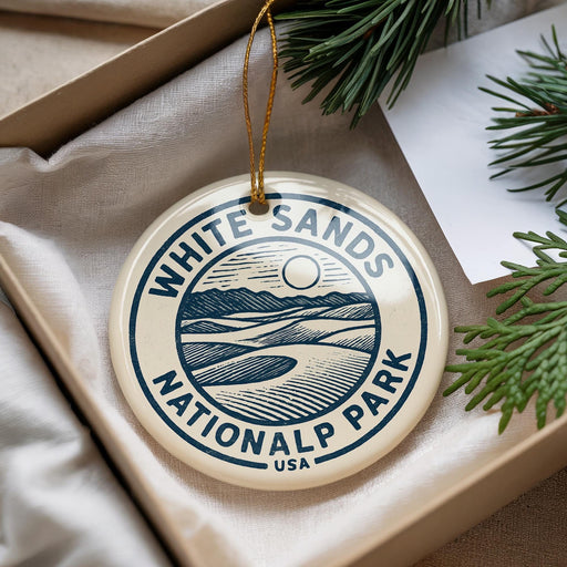A circular ornament with the text "WHITE SAND'S NATIONAL PARK USA" printed on it, hanging from a string.