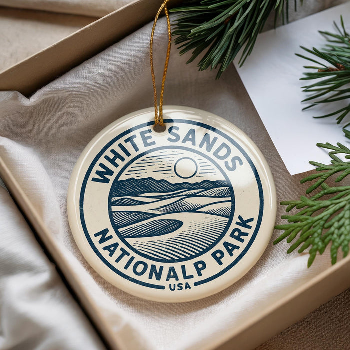 A circular ornament with the text "WHITE SAND'S NATIONAL PARK USA" printed on it, hanging from a string.