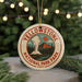 A circular ornament with the text "Yellowstone National Park" and an illustration of a mountain, steam, and pine trees, hanging from a string.