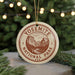 A circular ornament with the text "YOSEMITE NATIONAL PARK USA" printed on it, featuring an illustration of Yosemite National Park.