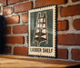 A metal sign with a ladder image is mounted on a brick wall, indicating a "Ladder Shelf" or a similar type of shelving unit.