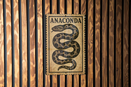 a sign with the word "Anaconda" on it, which is mounted on a wooden wall.