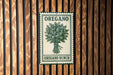 A sign for "Oregano Bunch" is displayed on a wooden wall, featuring a green and white illustration of an oregano plant.