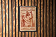 A red and white postage stamp featuring a dog, with the text "Yakutian Laika" printed on it, is displayed on a wooden wall.