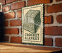 A sign for a crochet blanket is displayed on a brick wall.